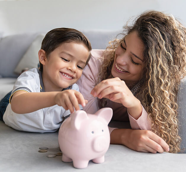mom with child saving money in piggy bank